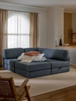 Divano letto angolare in bouclé con contenitore Ladina