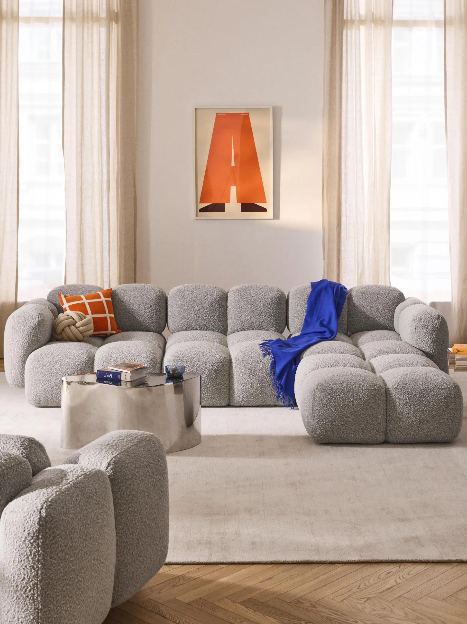 Divano componibile 4 posti in bouclé con poggiapiedi (sinistra/destra) Tayla