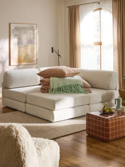 Divano letto angolare in bouclé con contenitore Ladina