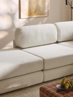 Divano letto angolare in bouclé con contenitore Ladina
