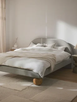 Letto imbottito con piedini rotondi in legno di quercia Rena